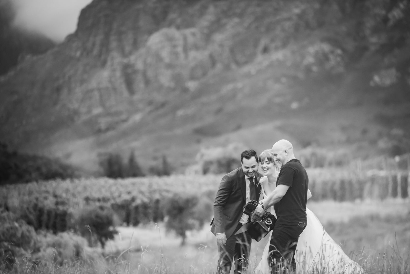 The team filming a couple beneath the mountains